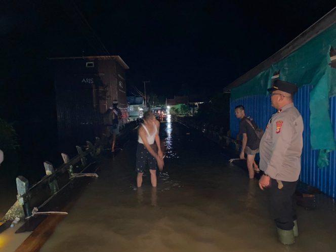 
					Terobos Genangan Air Malam Hari, Personel Polsek Tewah Jalan Kaki Sisir Pemukiman Banjir